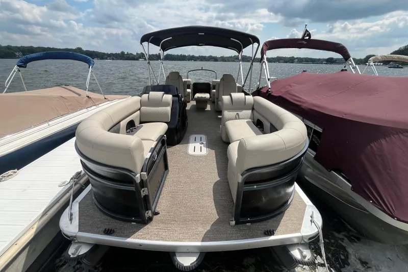 Slide: The Image of 2020 Premier 230 SunSation RF pontoon boat with spacious seating on a sunny lake. - 60