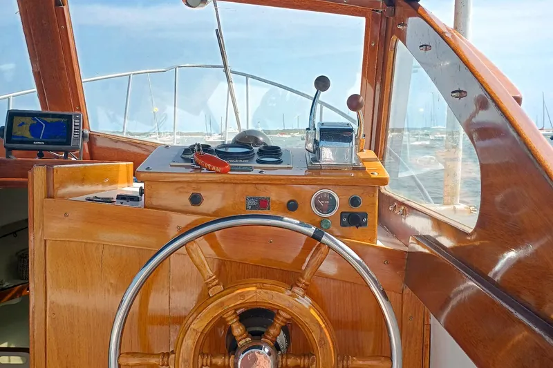 Slide: The Image of Helm of 1981 Dyer 29 boat with wooden steering wheel and navigation equipment. - 4