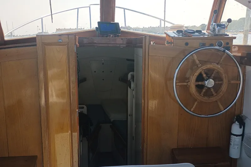 Slide: The Image of Interior of 1981 Dyer 29 boat with wooden steering wheel and cabin entrance. - 6
