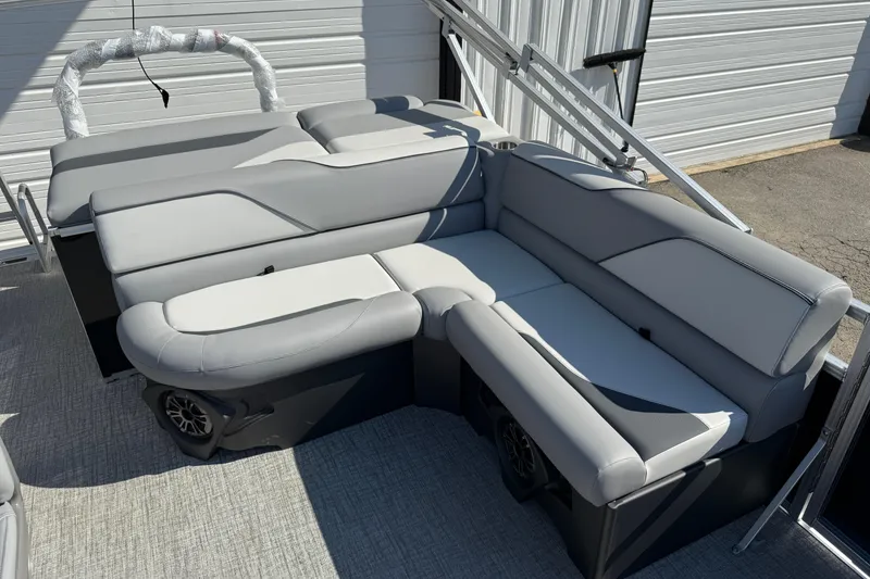 Slide: The Image of 2026 Tahoe Pontoon Sport 85 Cruise on trailer with American flag, parked outdoors. - 4