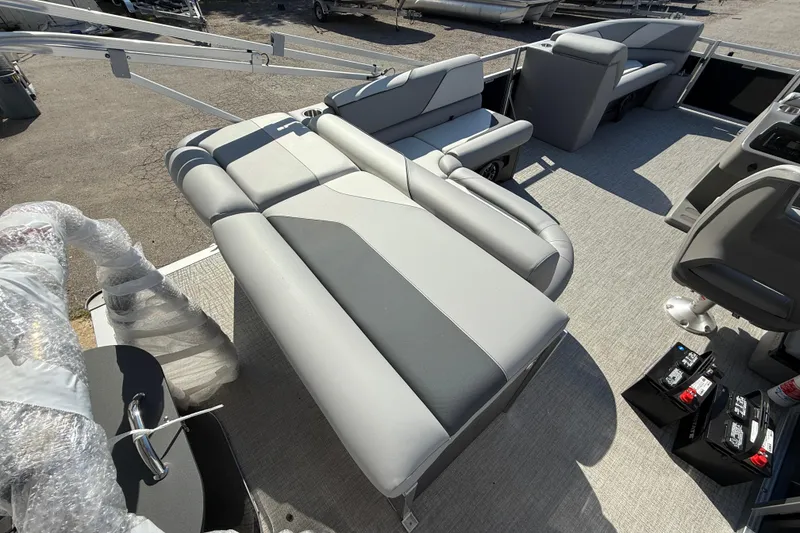Slide: The Image of 2026 Tahoe Pontoon Sport 85 Cruise on trailer, featuring spacious seating and American flag. - 5