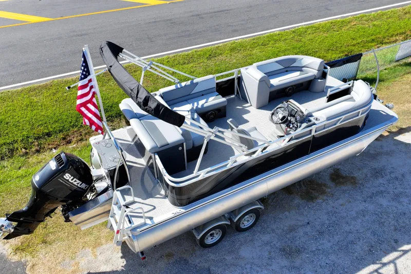 Slide: The Image of 2026 Tahoe Pontoon Sport 85 Cruise helm with steering wheel and gray captain's chair. - 9