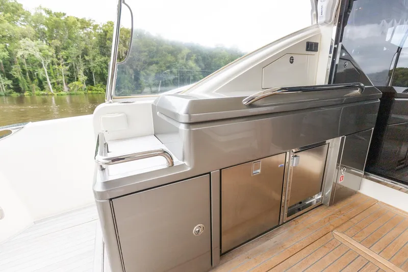 Slide: The Image of 2021 Riviera 5400 Sport Yacht Platinum Edition outdoor kitchen area with sleek stainless steel design. - 21