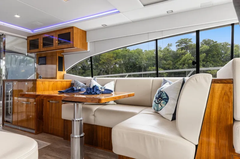 Slide: The Image of Luxurious interior of 2021 Riviera 5400 Sport Yacht Platinum Edition with elegant seating and wood finishes. - 26