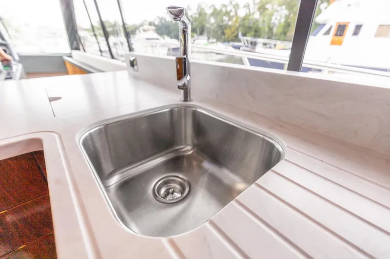 Slide: The Image of Stainless steel sink on 2021 Riviera 5400 Sport Yacht Platinum Edition. - 32