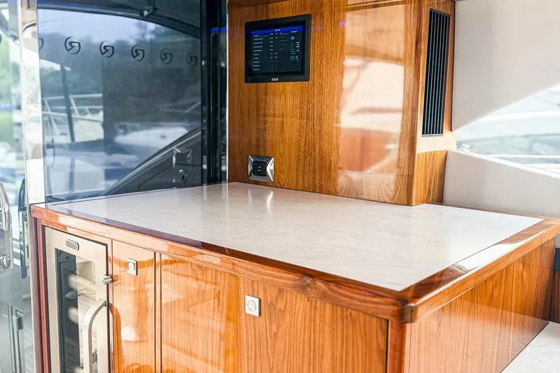 Slide: The Image of Luxurious interior of 2021 Riviera 5400 Sport Yacht Platinum Edition with wood finish and modern amenities. - 34