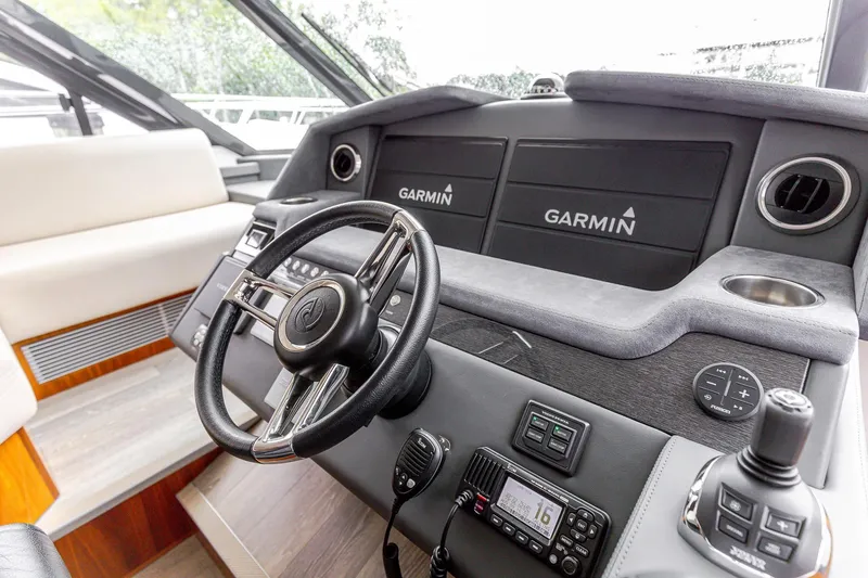 Slide: The Image of 2021 Riviera 5400 Sport Yacht helm with Garmin navigation system and modern controls. - 44