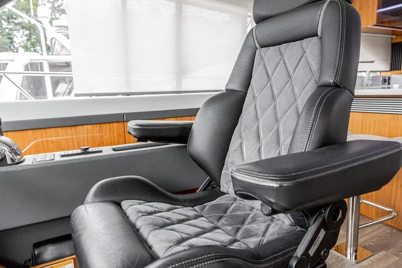 Slide: The Image of Luxurious leather seat in 2021 Riviera 5400 Sport Yacht Platinum Edition cockpit. - 46