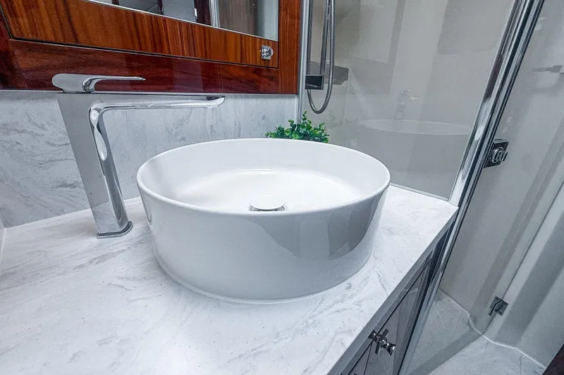 Slide: The Image of Modern bathroom sink in 2021 Riviera 5400 Sport Yacht Platinum Edition, featuring sleek design. - 53