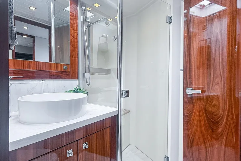 Slide: The Image of Luxurious bathroom in 2021 Riviera 5400 Sport Yacht Platinum Edition with modern fixtures. - 54