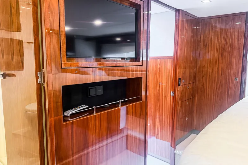 Slide: The Image of Luxurious interior of 2021 Riviera 5400 Sport Yacht Platinum Edition with wood paneling and TV. - 68