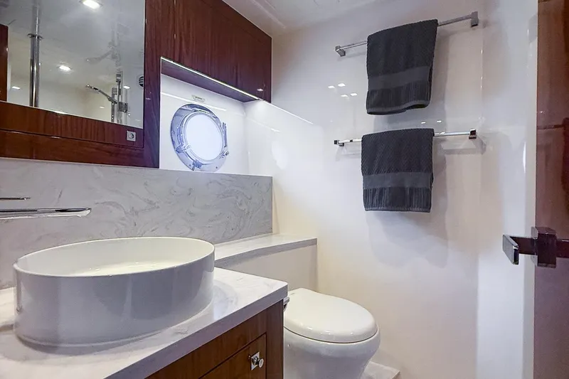 Slide: The Image of Luxurious bathroom in 2021 Riviera 5400 Sport Yacht Platinum Edition with modern fixtures. - 69