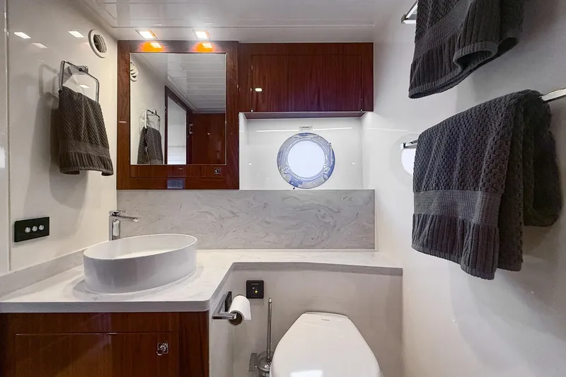Slide: The Image of Luxurious bathroom in 2021 Riviera 5400 Sport Yacht Platinum Edition with modern fixtures and elegant design. - 70