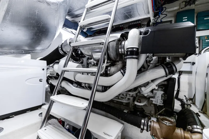 Slide: The Image of Engine room of 2021 Riviera 5400 Sport Yacht Platinum Edition with ladder and machinery. - 72