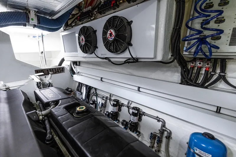 Slide: The Image of Engine room of 2021 Riviera 5400 Sport Yacht Platinum Edition, showcasing mechanical components. - 80