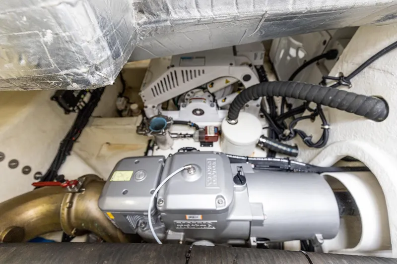 Slide: The Image of Engine room of 2021 Riviera 5400 Sport Yacht Platinum Edition, showcasing mechanical components. - 81