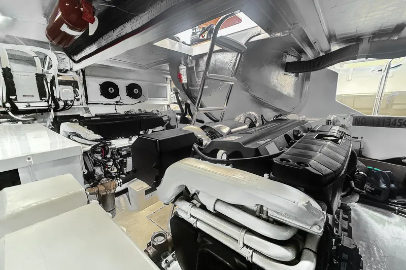 Slide: The Image of Engine room of 2021 Riviera 5400 Sport Yacht Platinum Edition, showcasing advanced machinery and equipment. - 84
