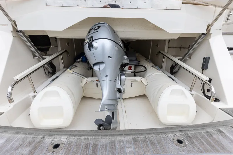 Slide: The Image of 2021 Riviera 5400 Sport Yacht Platinum Edition with stored inflatable boat and motor. - 86