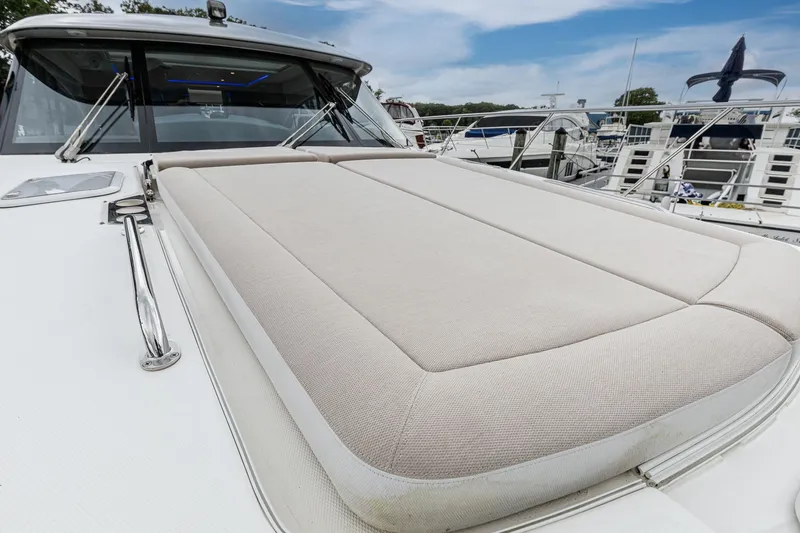 Slide: The Image of 2021 Riviera 5400 Sport Yacht Platinum Edition with spacious sunbed on deck. - 9