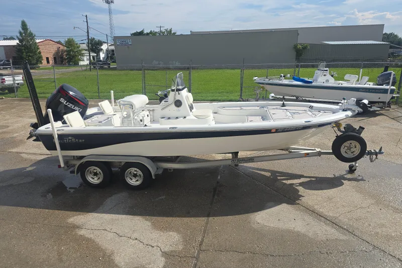 Slide: The Image of 2009 NauticStar 2200 Nautic Bay boat on trailer, parked outdoors. - 1