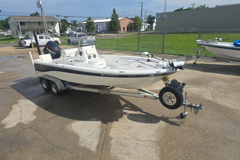 Slide: The Image of 2009 NauticStar 2200 Nautic Bay boat on trailer, parked outdoors. - 3