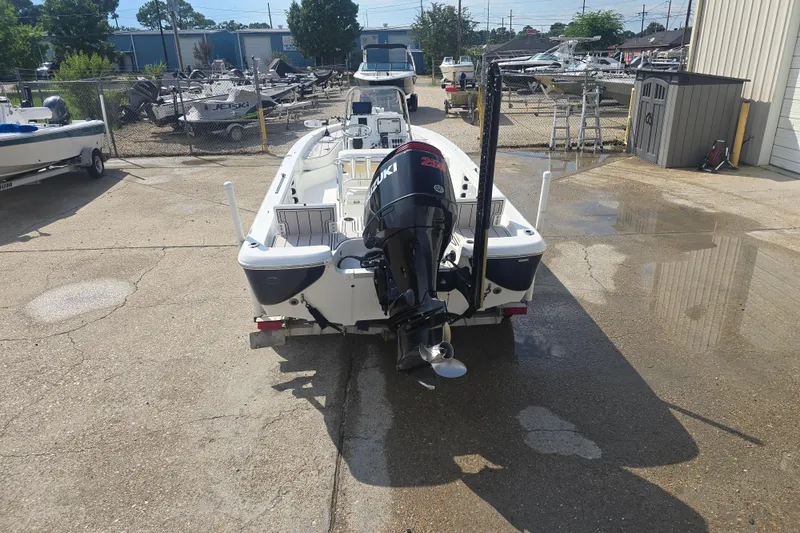 Slide: The Image of 2009 NauticStar 2200 Nautic Bay boat with Suzuki outboard motor in a marina setting. - 5