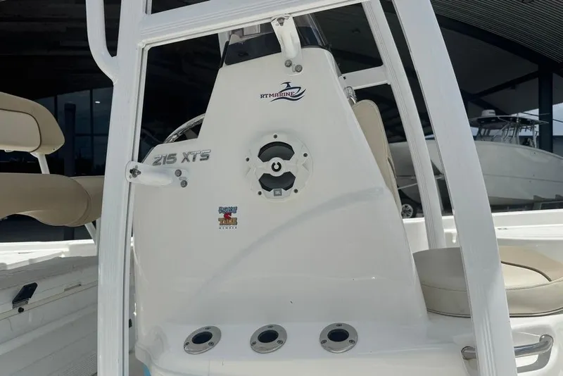 Slide: The Image of 2022 NauticStar 215 XTS boat console with seating and steering wheel. - 14