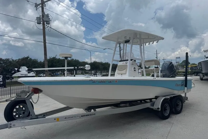 Slide: The Image of 2022 NauticStar 215 XTS boat on trailer under cloudy sky. - 3
