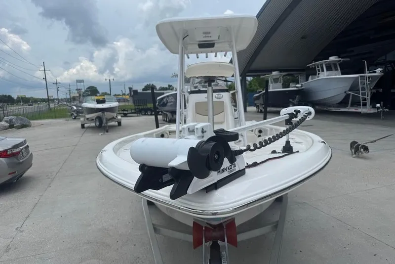 Slide: The Image of 2022 NauticStar 215 XTS boat with Minn Kota trolling motor in a dealership lot. - 4
