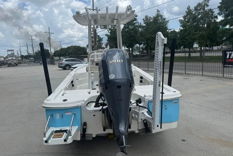 Slide: The Image of 2022 NauticStar 215 XTS boat with powerful outboard motor in a parking lot. - 8