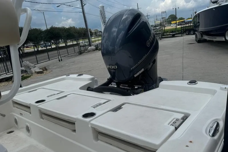 Slide: The Image of 2022 NauticStar 215 XTS boat with Yamaha 200 engine, docked outdoors. - 9