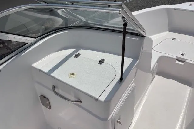 Slide: The Image of 2002 Pro-Line 20 DC boat interior with white seating and storage compartments. - 9