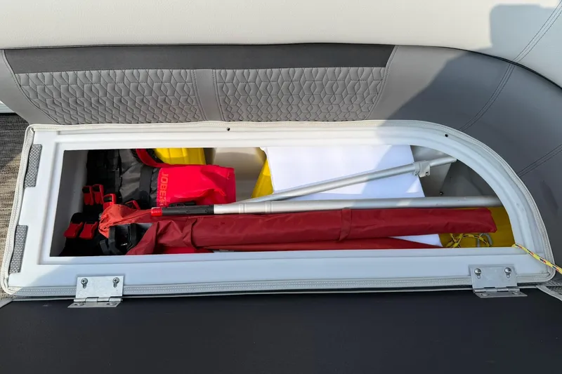 Slide: The Image of Storage compartment of 2021 Godfrey Sweetwater 2086 C boat with safety gear and equipment. - 11