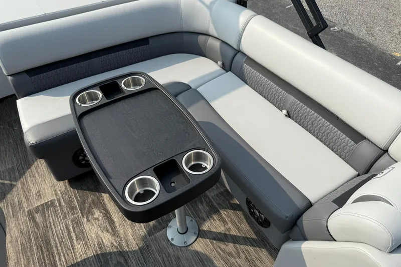 Slide: The Image of 2021 Godfrey Sweetwater 2086 C boat interior with cushioned seating and cupholder table. - 13