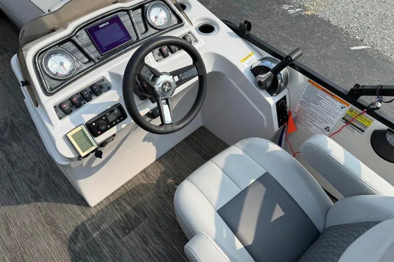 Slide: The Image of 2021 Godfrey Sweetwater 2086 C boat dashboard with steering wheel and control panel. - 14