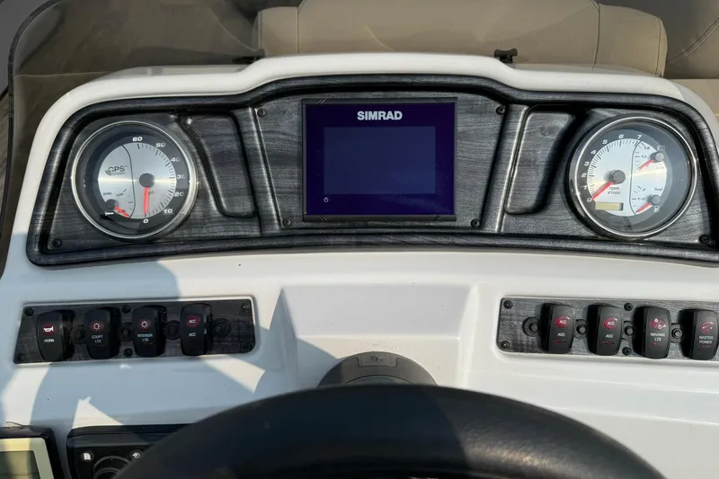 Slide: The Image of Dashboard of 2021 Godfrey Sweetwater 2086 C boat with gauges and controls. - 16