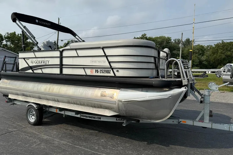 Slide: The Image of 2021 Godfrey Sweetwater 2086 C pontoon boat on trailer, parked outdoors. - 5