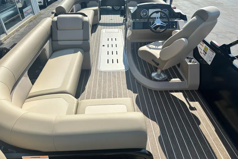 Slide: The Image of 2026 Premier 250 Angler boat interior with beige seating and modern steering console. - 11