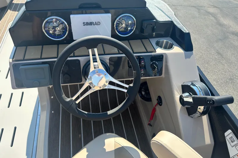 Slide: The Image of Steering console of 2026 Premier 250 Angler boat with Simrad display and controls. - 12