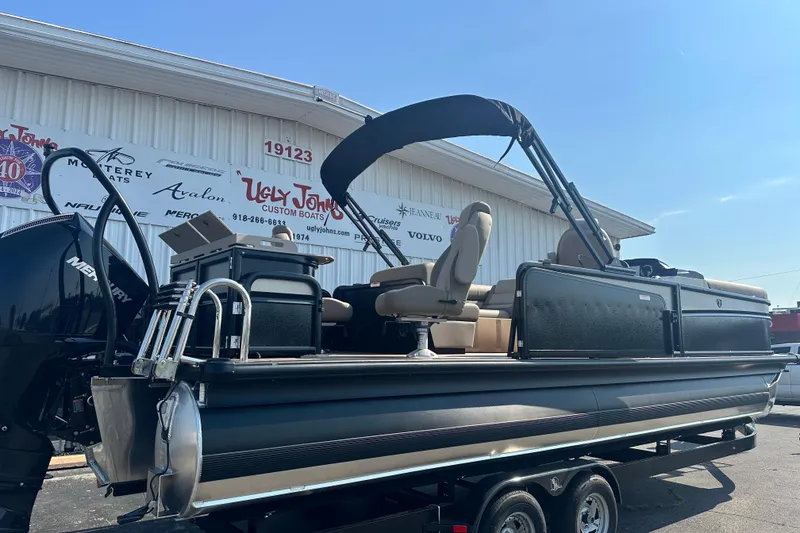 Slide: The Image of 2026 Premier 250 Angler pontoon boat on trailer at dealership, featuring sleek design and modern amenities. - 4