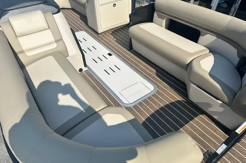 Slide: The Image of 2026 Premier 250 Angler boat interior with beige seating and striped flooring. - 6
