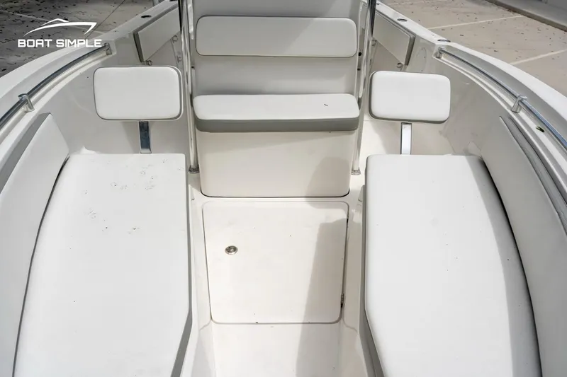Slide: The Image of Interior view of a 2020 Release 210 RX boat, featuring white seating and clean design. - 9