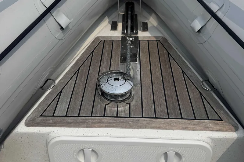 Slide: The Image of 2016 Protector 30 Center Console boat deck with wood finish and anchor chain. - 13