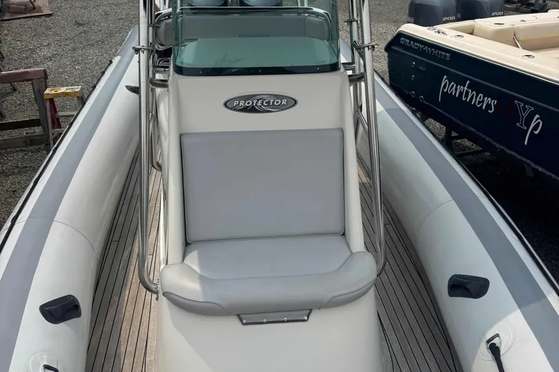 Slide: The Image of 2016 Protector 30 Center Console boat with cushioned seating and sleek design. - 14