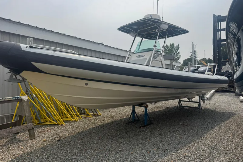 Slide: The Image of 2016 Protector 30 Center Console boat on stands in a gravel yard. - 2