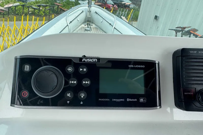 Slide: The Image of Control panel of a 2016 Protector 30 Center Console boat with Fusion MS-UD650 system. - 4