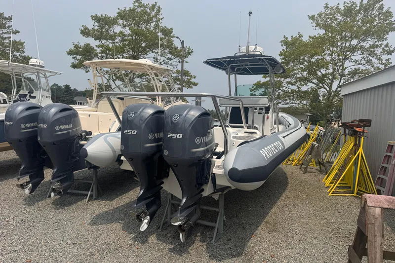 Slide: The Image of 2016 Protector 30 Center Console boat with Yamaha outboard engines, parked on gravel. - 9