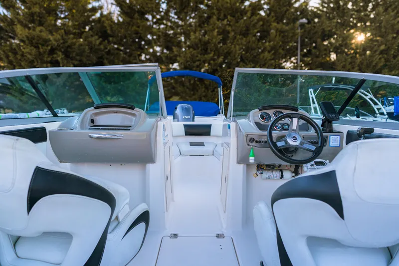 Slide: The Image of 2018 Chaparral 210 Suncoast boat interior with steering wheel and seating. - 1