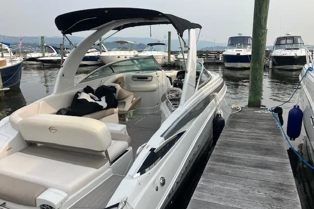 Slide: The Image of 2016 Monterey 275 Sport Yacht docked at marina with other boats in background. - 2