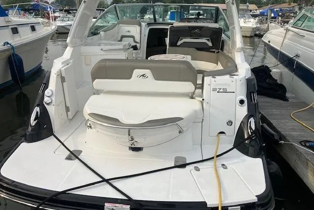 Slide: The Image of 2016 Monterey 275 Sport Yacht docked, featuring spacious seating and sleek design. - 5